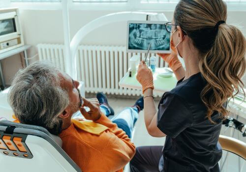 Dentist looking at x-rays with client.