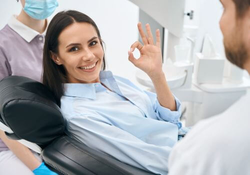 happy woman at the dentist office after a root canal